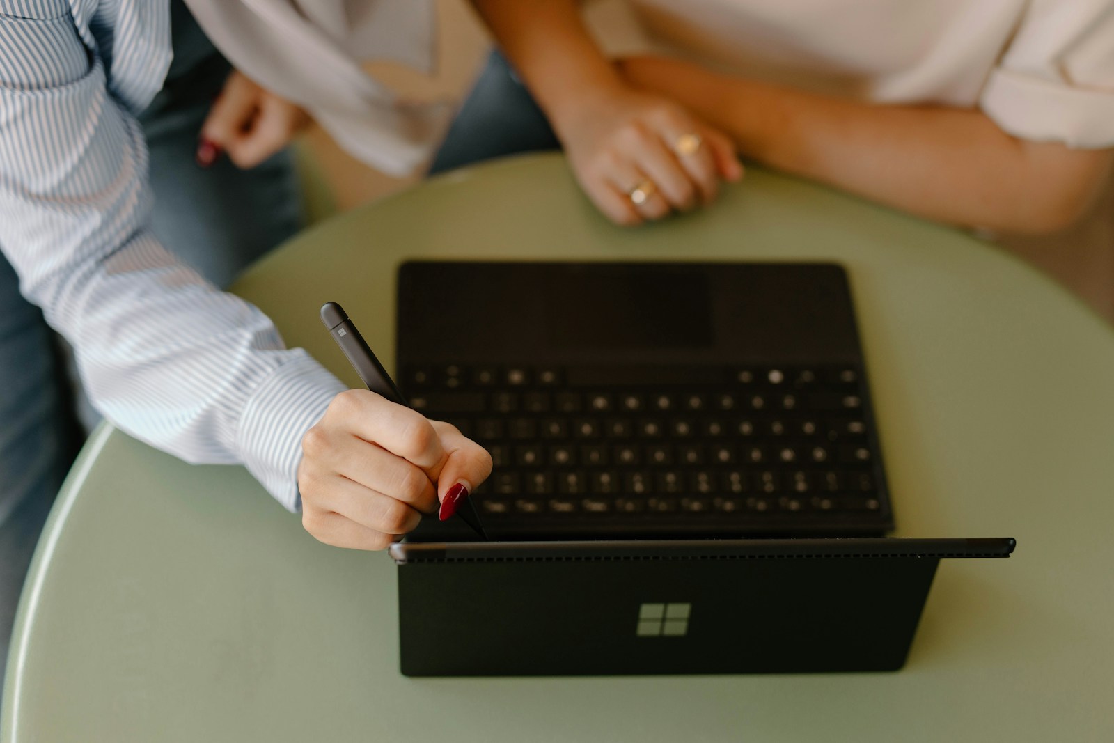Designers collaborating around a laptop and digital workspace